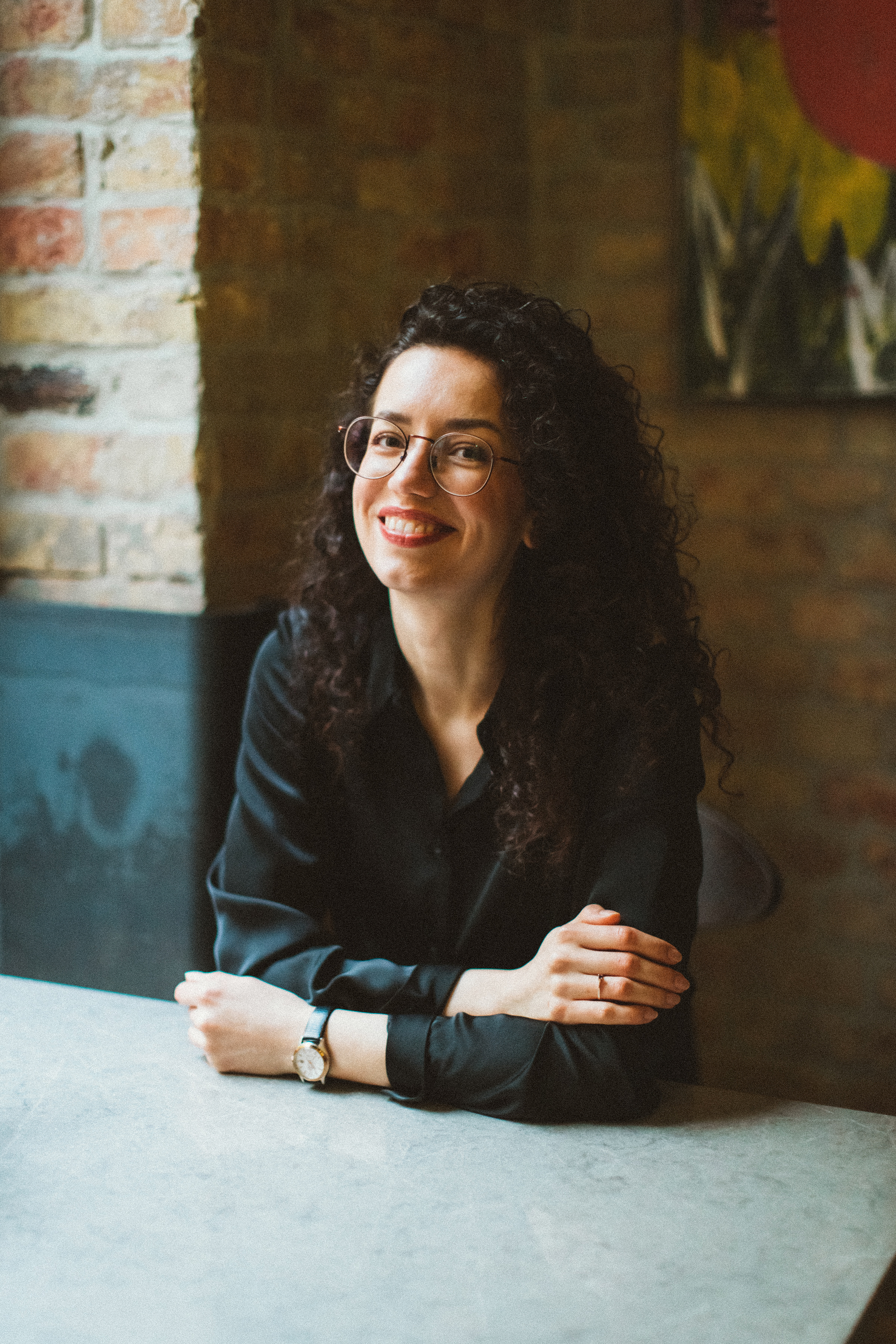 Smiling person sitting in a café